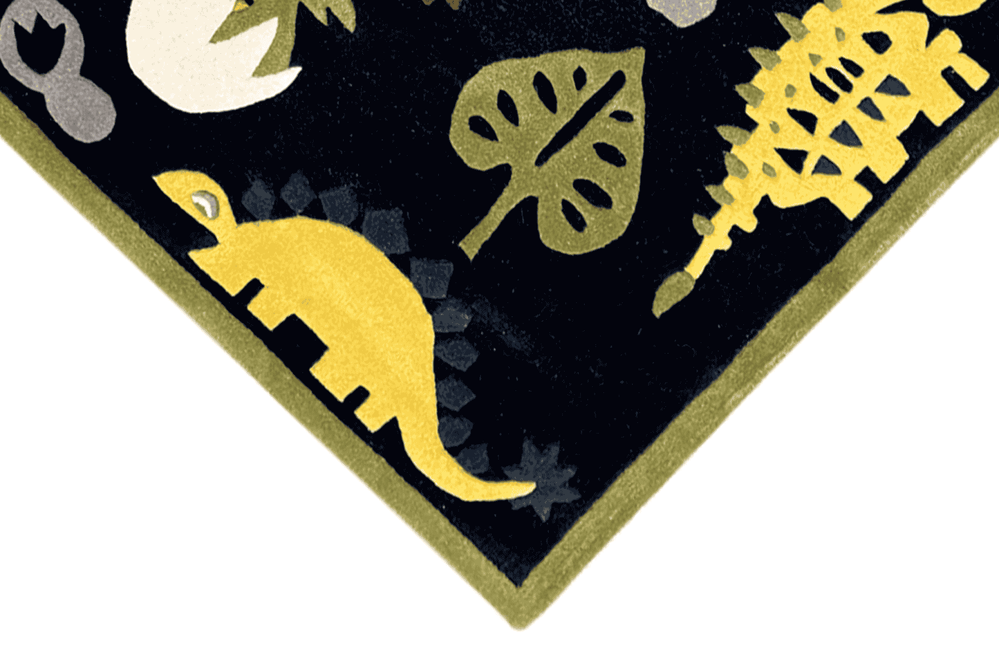 Corner detail: yellow dinosaurs and leaves on a dark blue children's rug