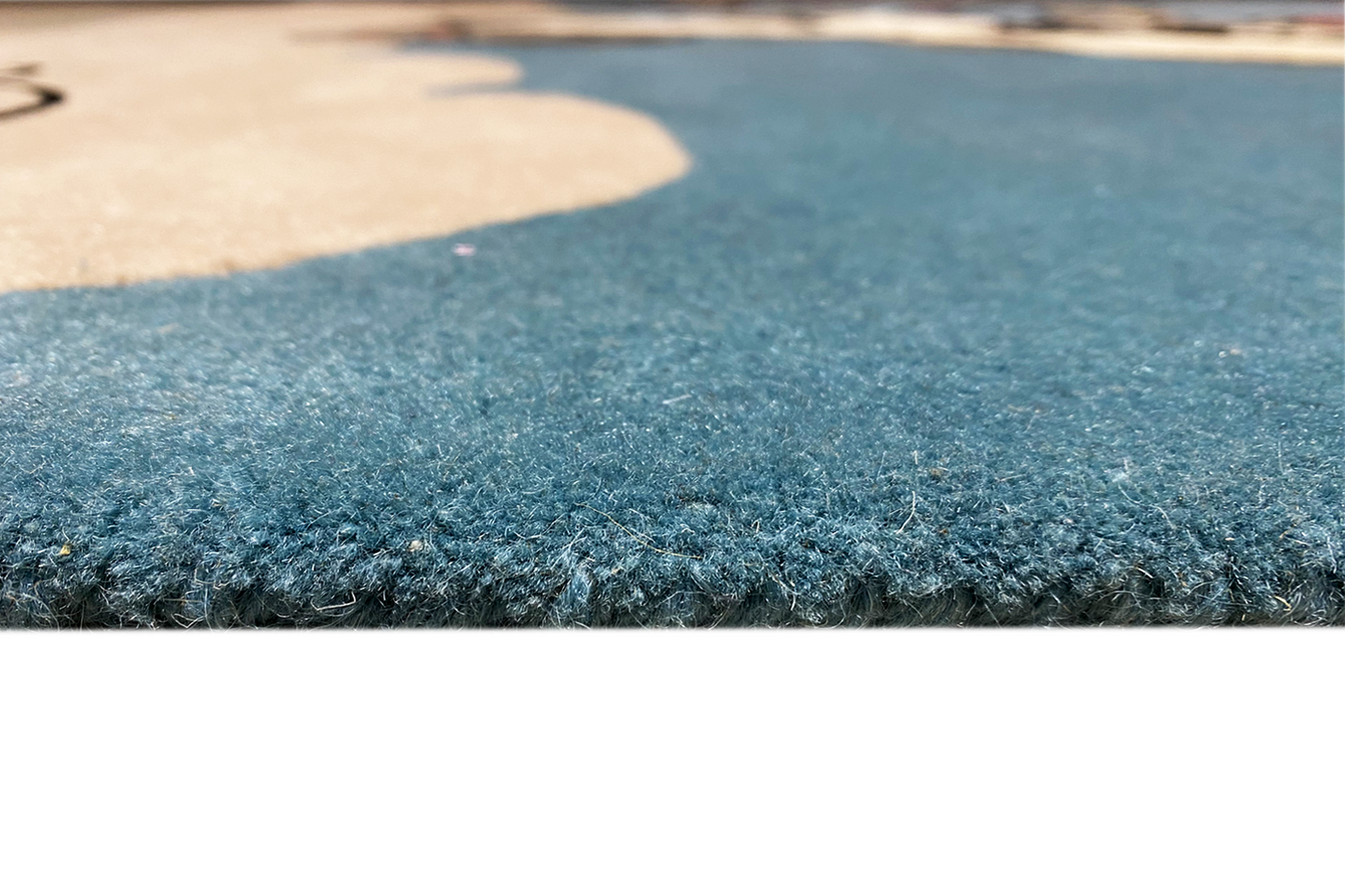 Close-up: blue carpet pile with a soft, dense texture