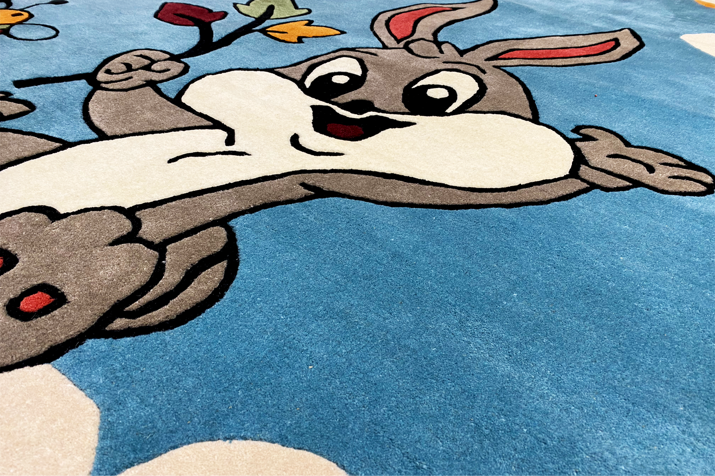 Close-up: drawn bunny face and paws on a blue carpet