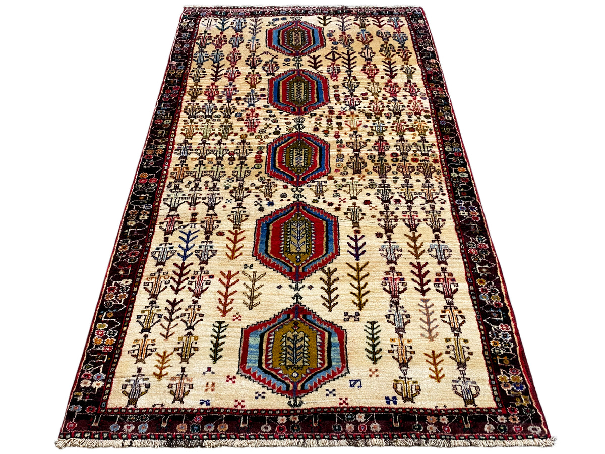 Baluch rug, cream with dark borders and tiered hexagons, approx. 176x99 cm
