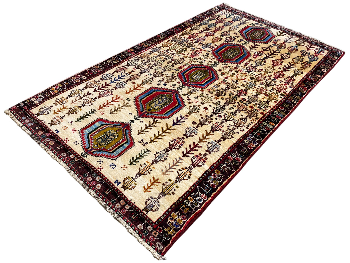 Baluch rug, cream with colored hexagons and many plant motifs, approx. 176x99 cm