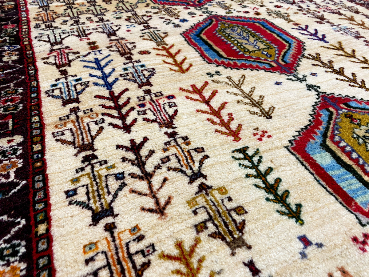 Baluch rug close-up with rows of trees, fine lines and colorful diamonds