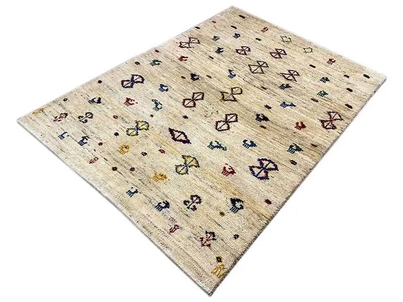 Gabbeh rug 164x116 cm, beige background with colorful diamond and animal motifs, angled
