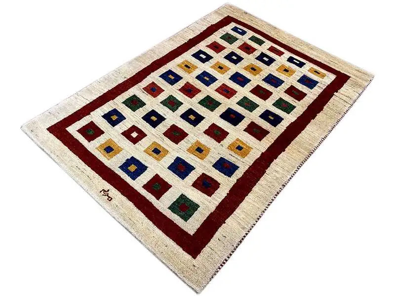 Gabbeh rug, rectangular, cream background with a red border and colorful square details