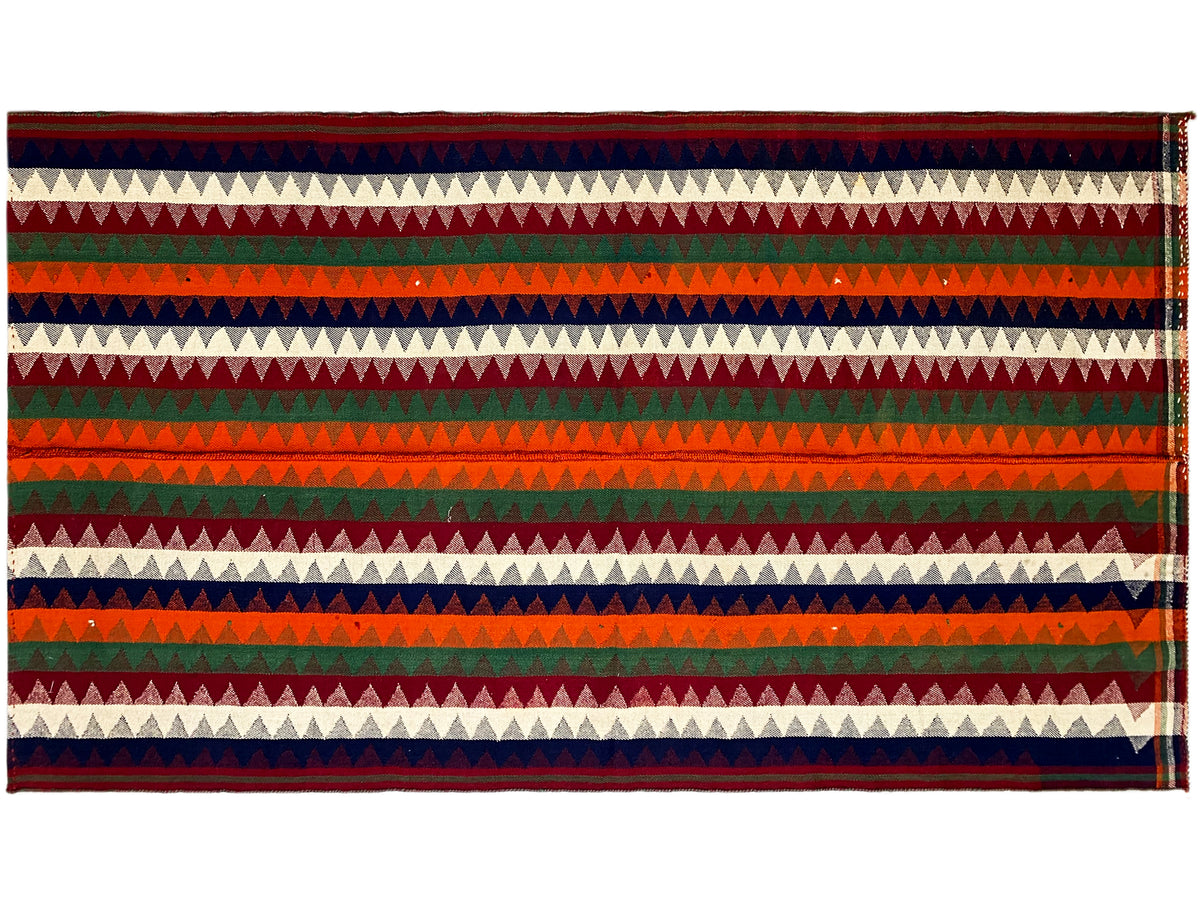 Jajim rug, horizontal view: horizontal zigzag and striped bands in red, green, blue, and cream