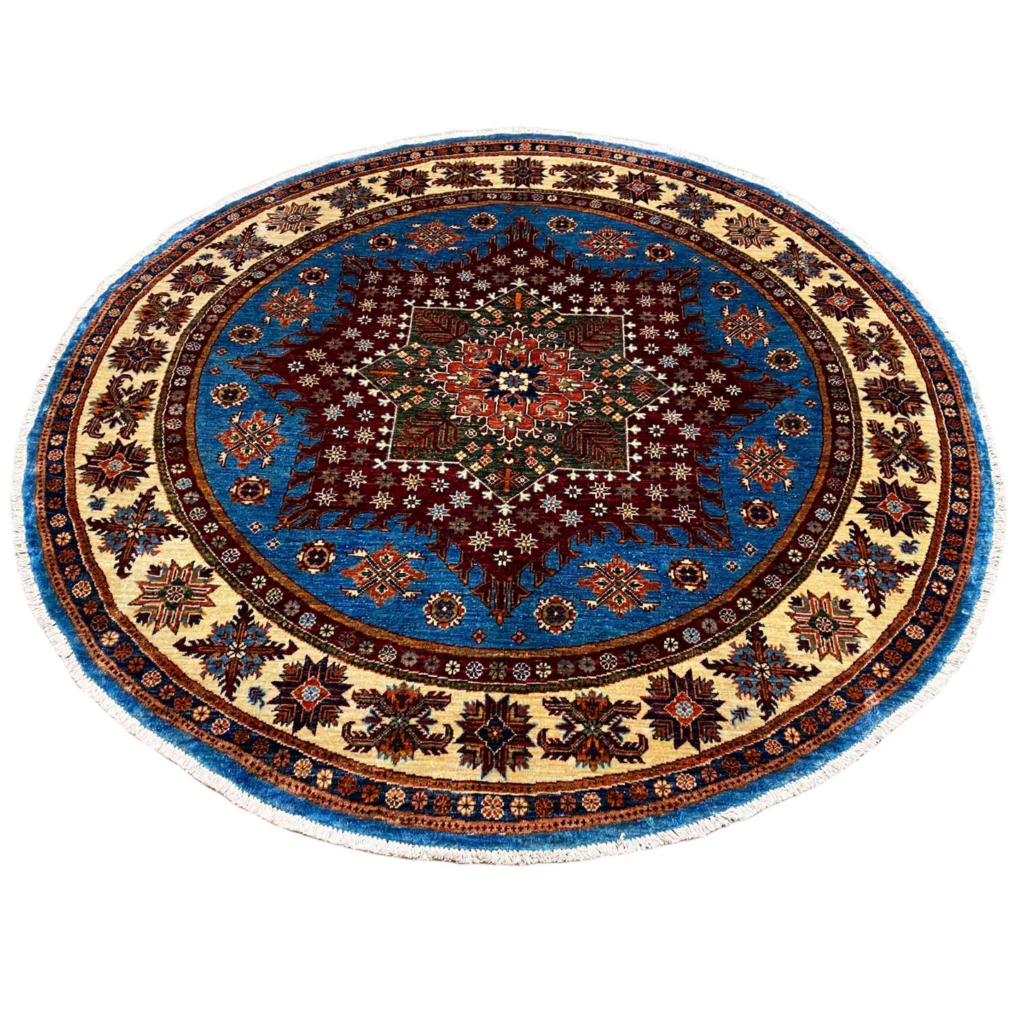 Round rug with a blue medallion, dark central star, and decorative border ornaments