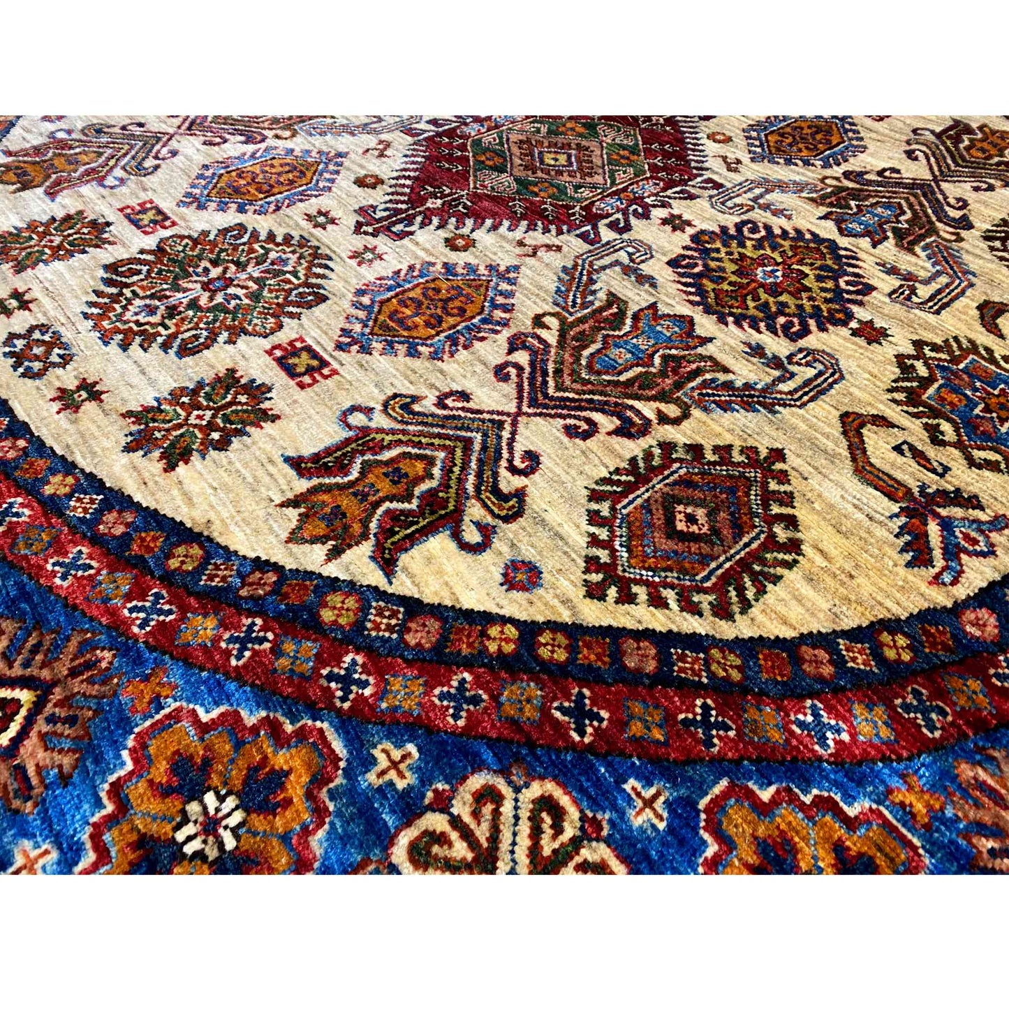 Close-up: carpet patterns in blue, red, and brown on a light background