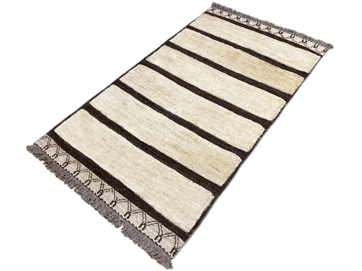 Kelim Gabbeh rug with cream-colored stripes and dark fields, fringes