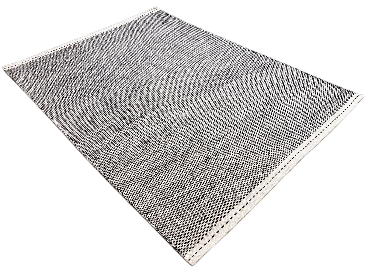 Woven rug, dark gray patterned, with border and dotted decorative stitching