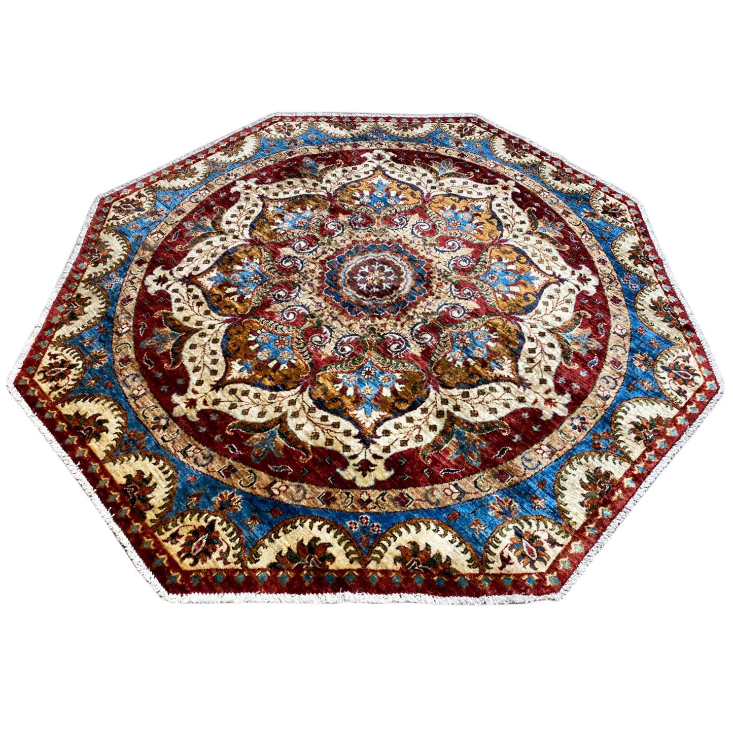 Octagonal rug with a symmetrical ornamental border in red, blue and cream