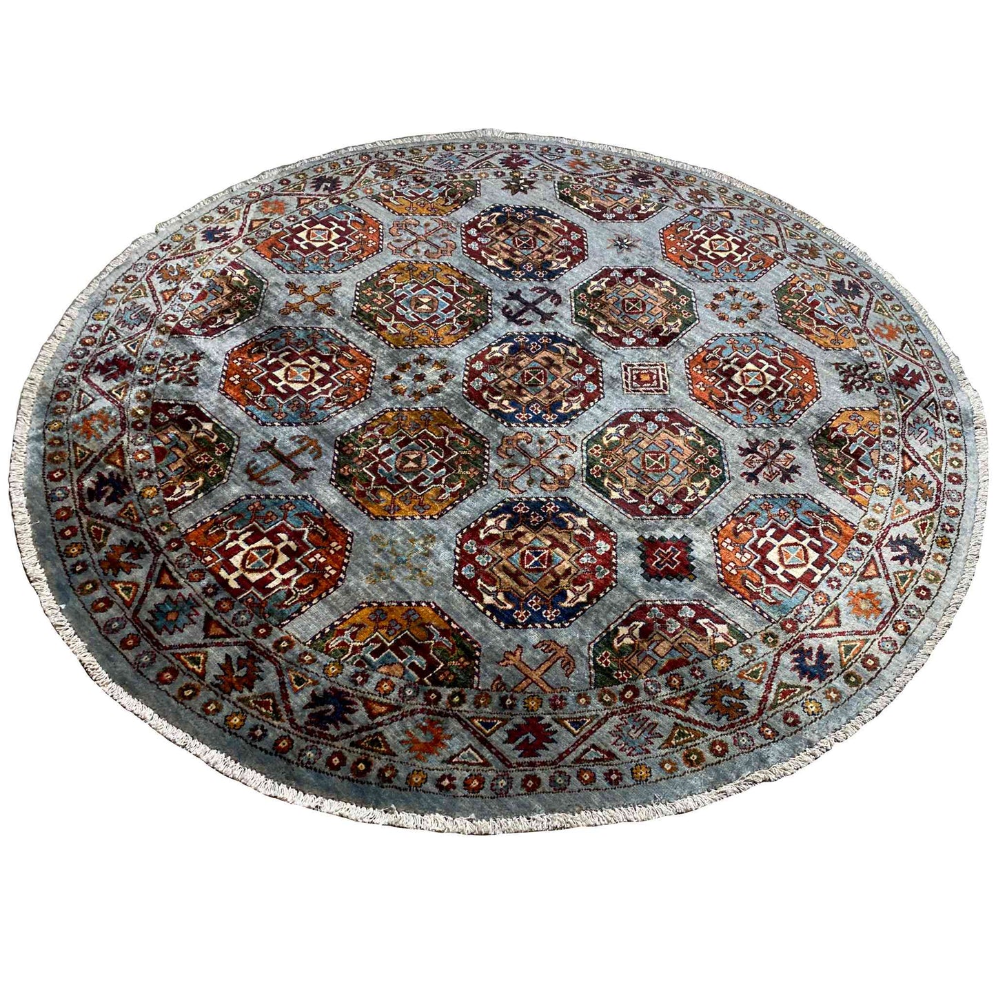Round rug: geometric hexagon patterns in orange, red, and blue on a light gray background
