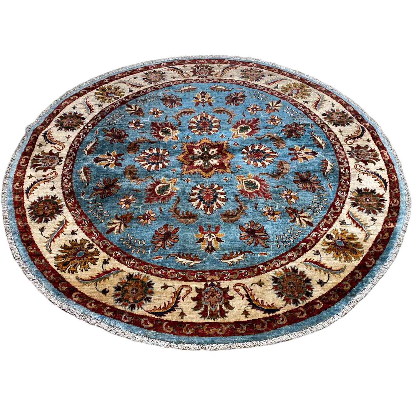 Round rug with a blue floral medallion, cream-colored border, and colorful decorative elements