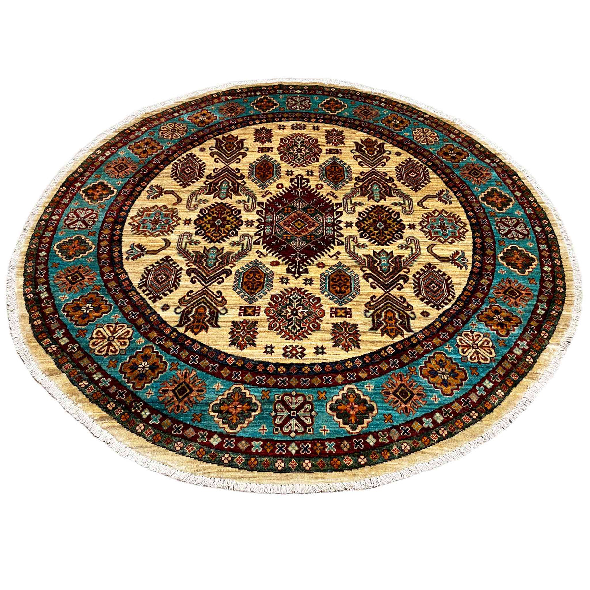 Round khorjin rug with a patchwork-style geometric pattern on a cream-colored background