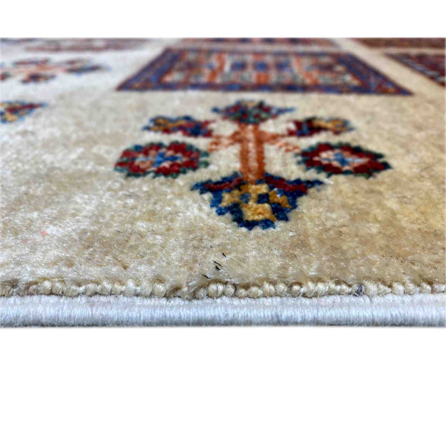 Close-up of the beige Afghan Khorjin rug: pile with colorful floral ornaments, with a border