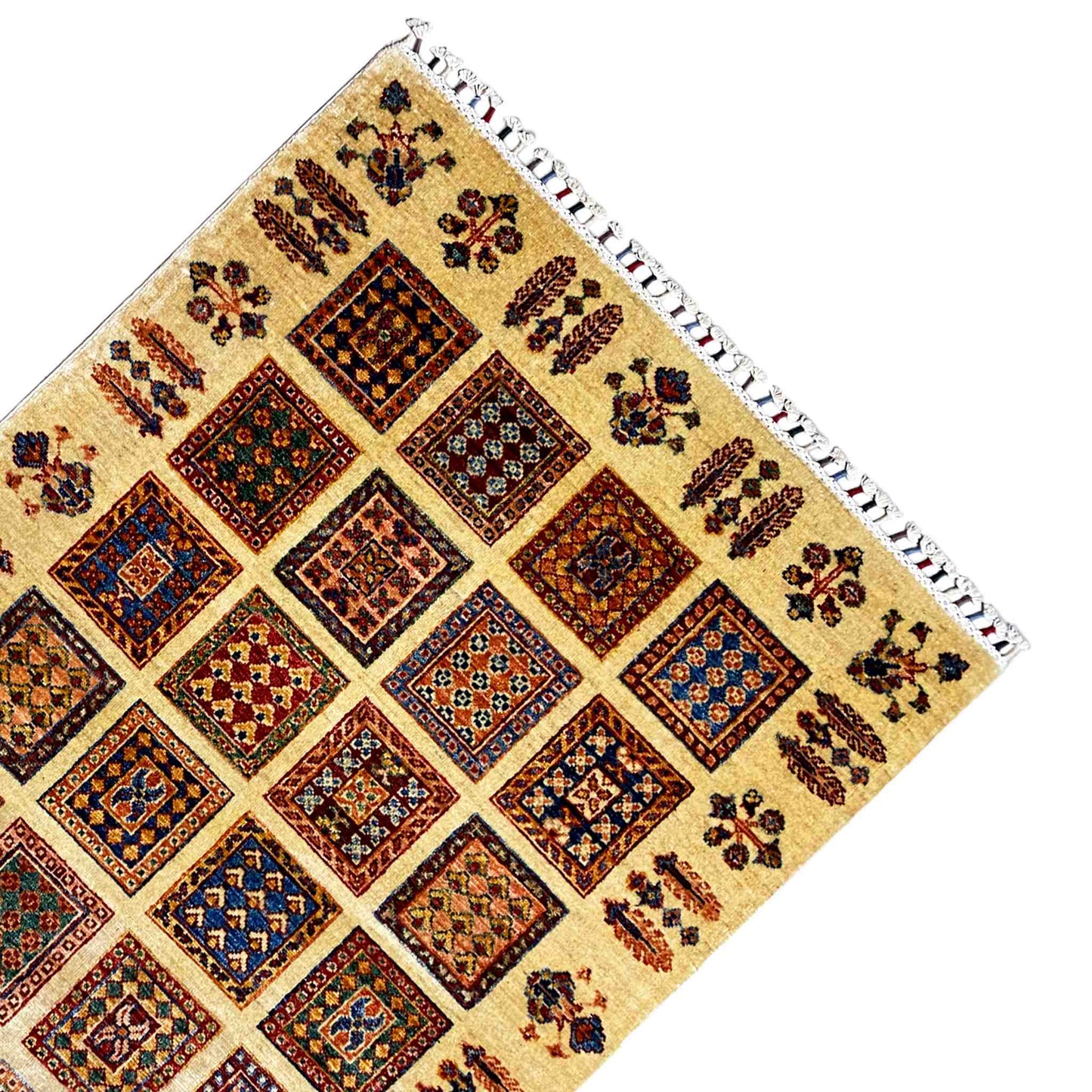 Beige Afghan Khorjin rug corner with a square diamond motif and white fringed border