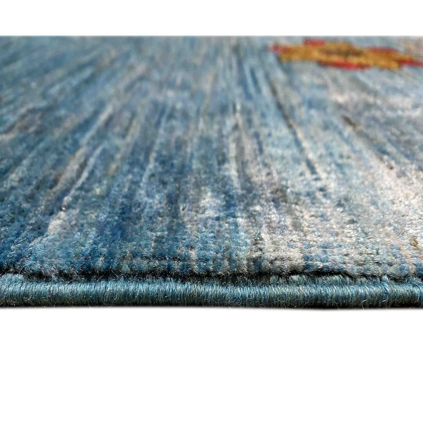 Blue rug with a fine texture and visible edge fringes