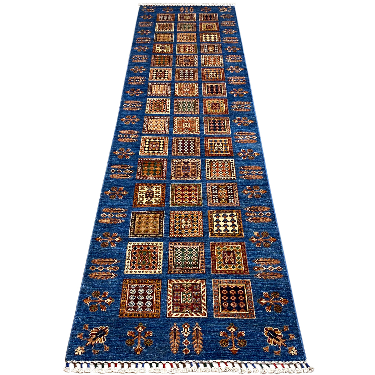 Khorjin runner with a geometric blue center band, fringes along the edge