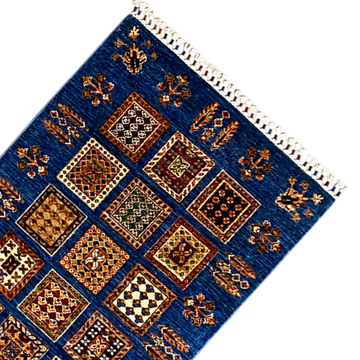Corner of the Khorjin runner, blue with patchwork squares and decorative fringe