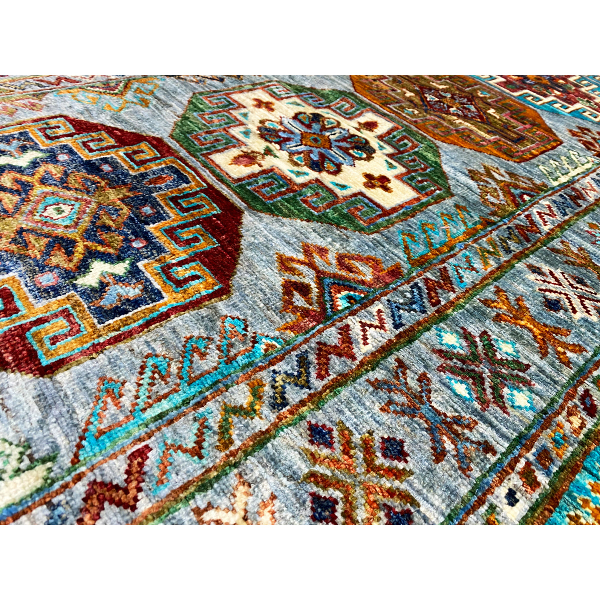 Close-up: Hand-knotted Khorjin runner with a colorful ornamental field and geometric patterns