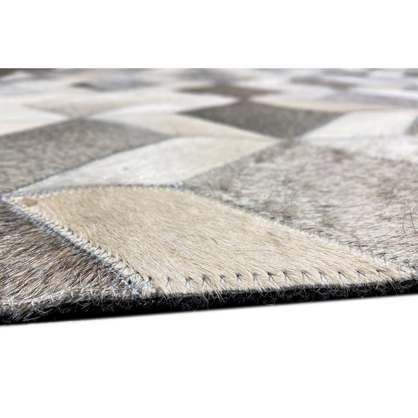 Rug edge with contrasting stitching and a short, dense pile surface