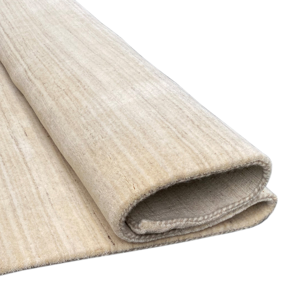 Natural gabbeh rug, folded edge, light texture with a dense pile surface
