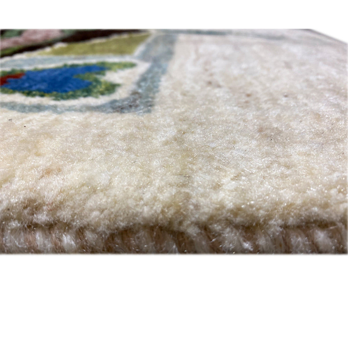Carpet pile with dense beige wool fibers and a fine, even pile structure
