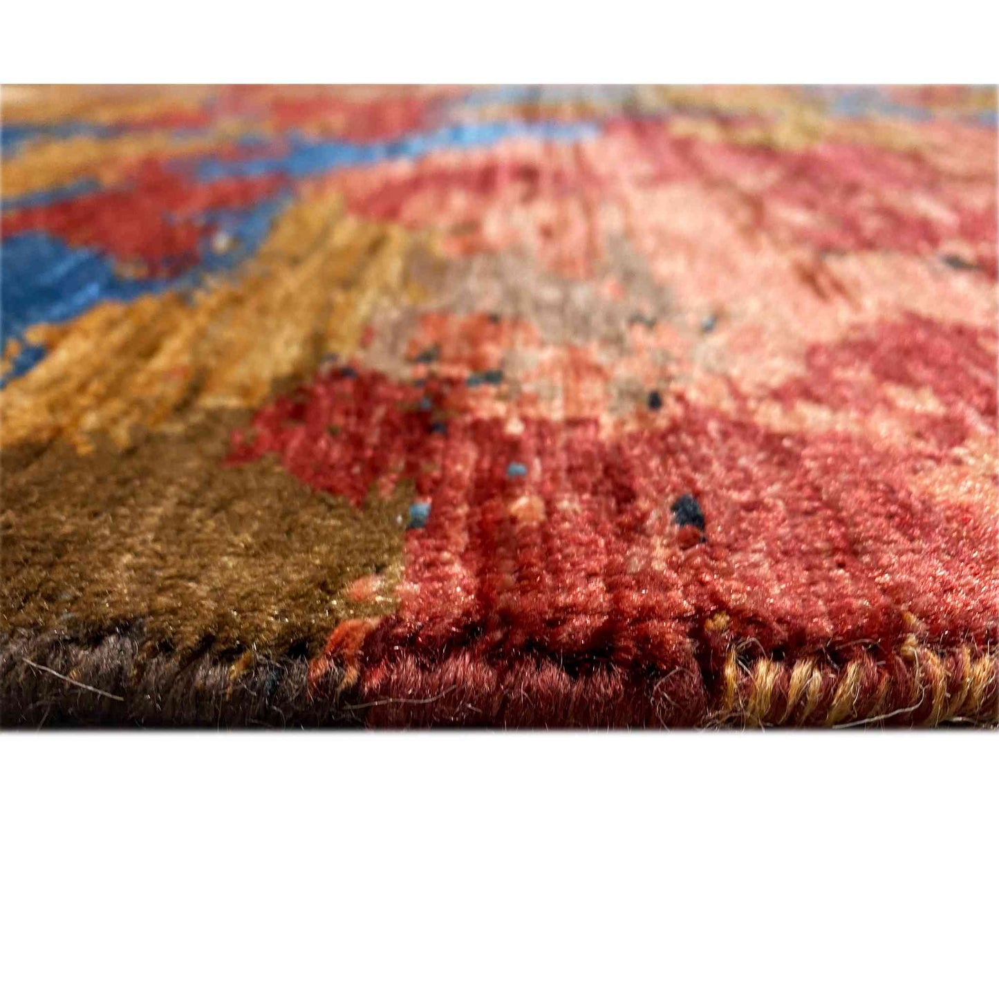 Rug pile in detail, rich red and blue tones, golden accents