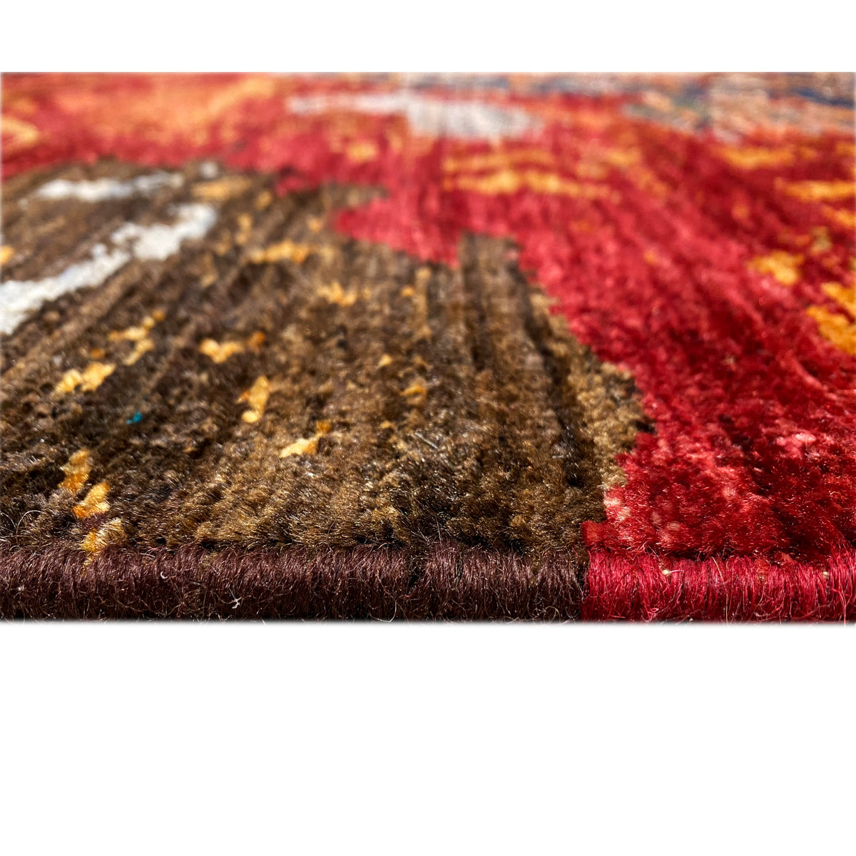 Hand-knotted Mamluk rug, close-up of the pile structure, red and brown color fields.