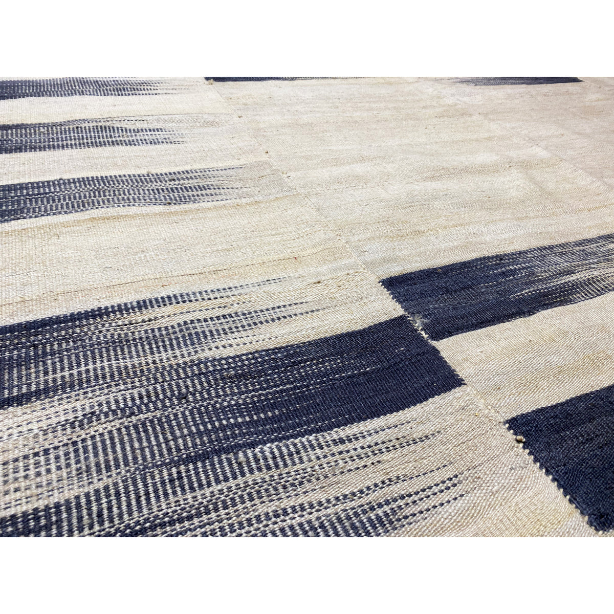 Detail of Persian kilim 315x198 cm: woven lines in cream and dark blue, fine texture