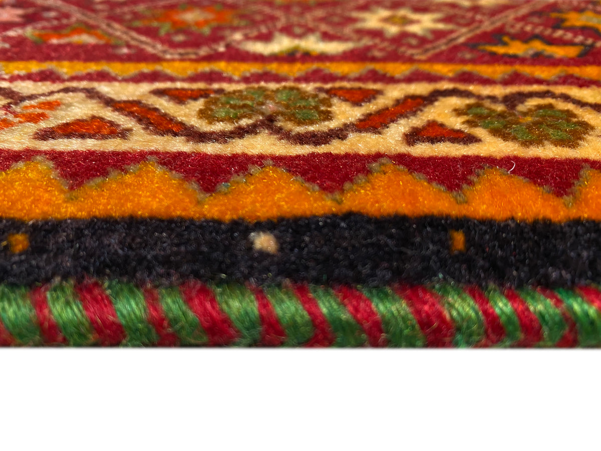 Poshti rug detail at the edge: colorful fringes and short pile on a white background.