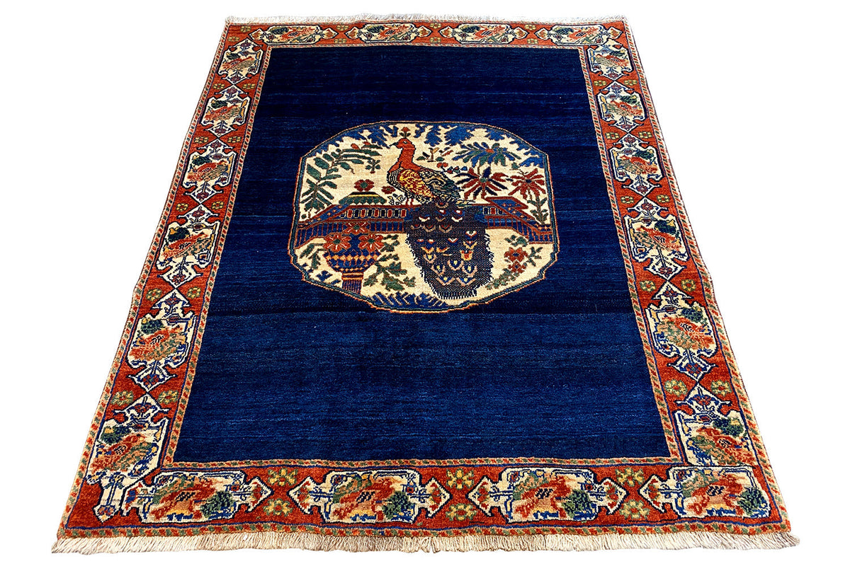 Blue rug 178x143 cm with a central animal motif and colorful border frame