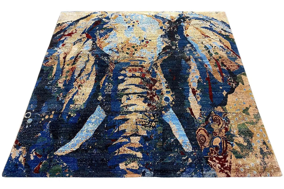 Gabbeh Lori rug with a blue, gold, and beige abstract pattern, angled