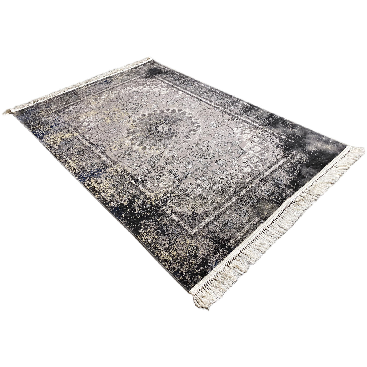 Vintage rug in gray, viewed at an angle, with a border and fringe