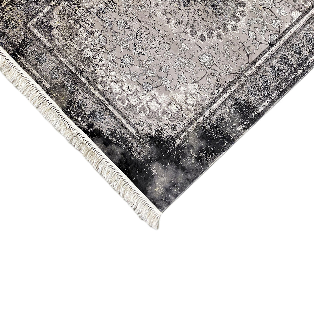 Corner of a vintage rug: gray ornamental pattern, decorative border, and fringe