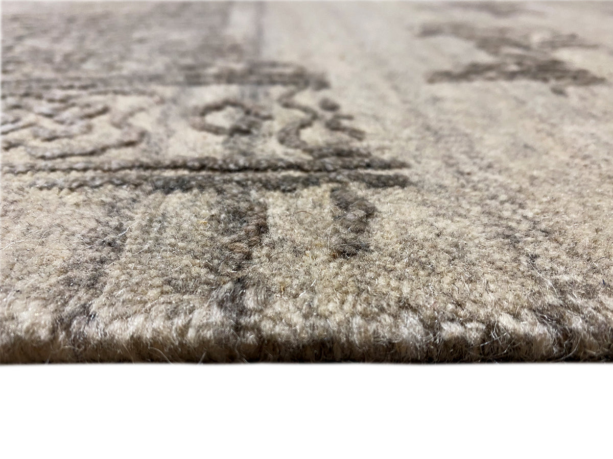 Close-up: Gray designer rug with a dense pile and a faded pattern