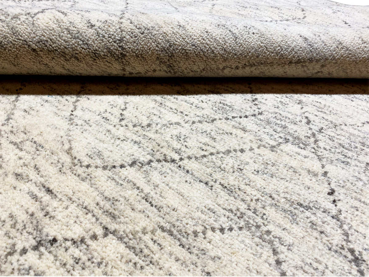Berber rug: visible pile height and layering, light beige with a gray linear pattern