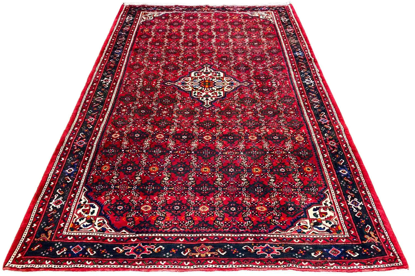 Red Oriental rug with a delicate clover pattern and wide border