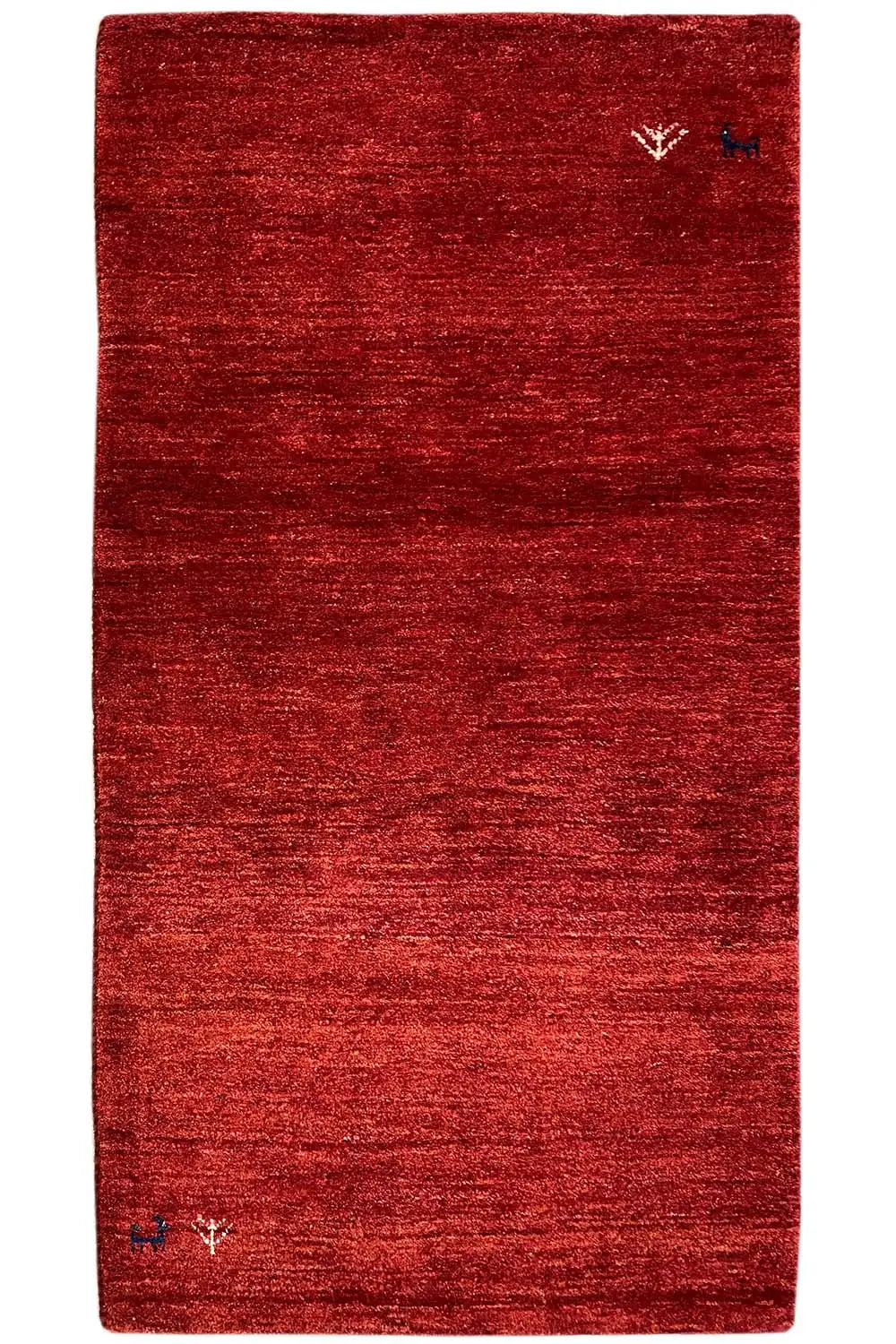 Reddish-brown Gabbeh rug with a subtle texture and small medallions in the corners