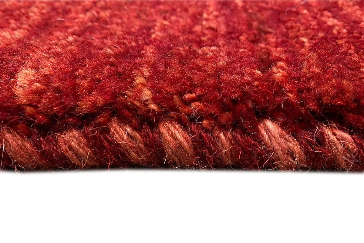 Gabbeh rug, close-up of the edge with dense red pile and individual fibers