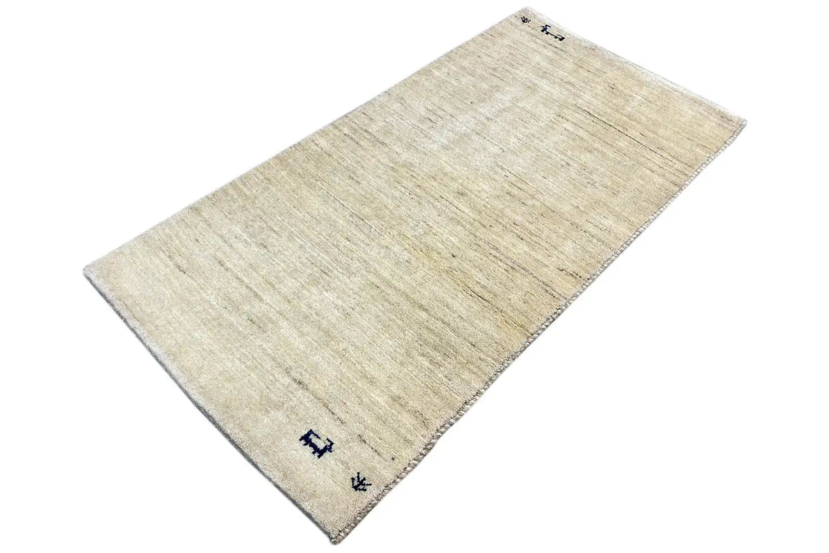 Gabbeh rug in light beige with a blue corner pattern, rectangular shape