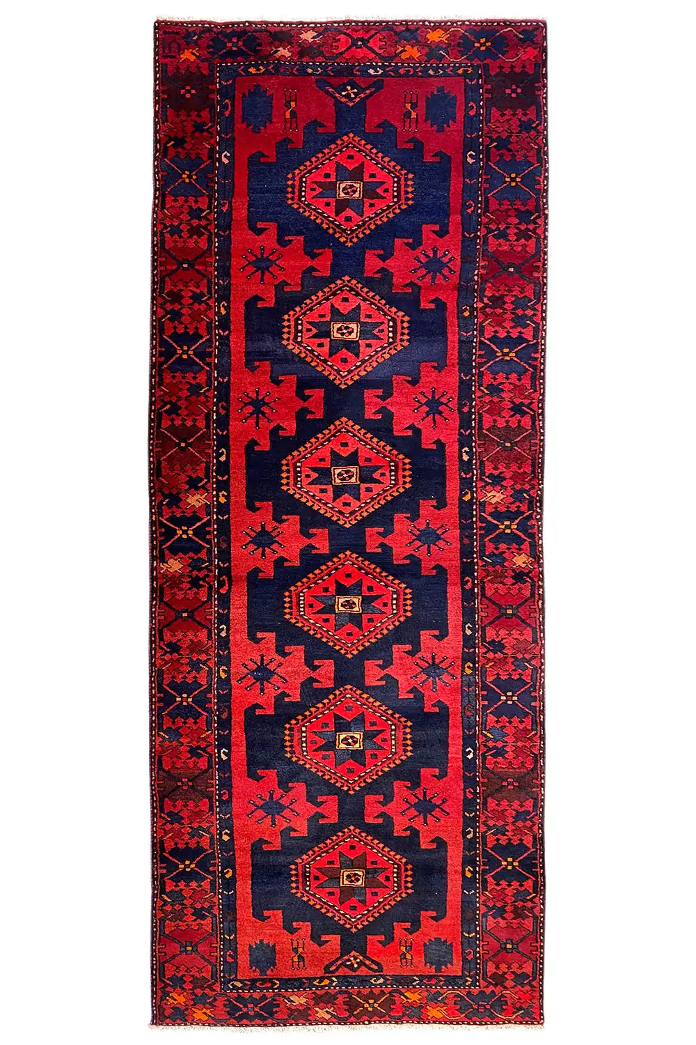 Knotted runner rug in red and dark blue with several medallions in the vertical border band.