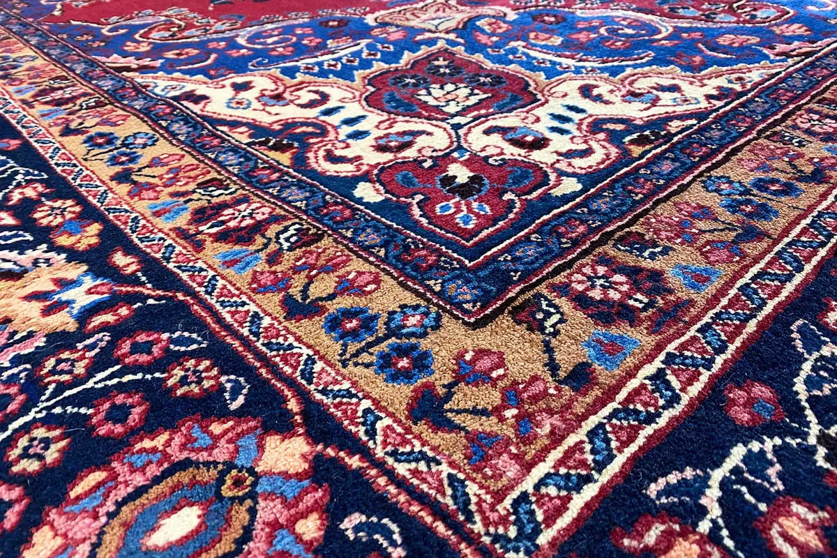 Rug with a blue and red medallion pattern and delicate ornaments, dense pile
