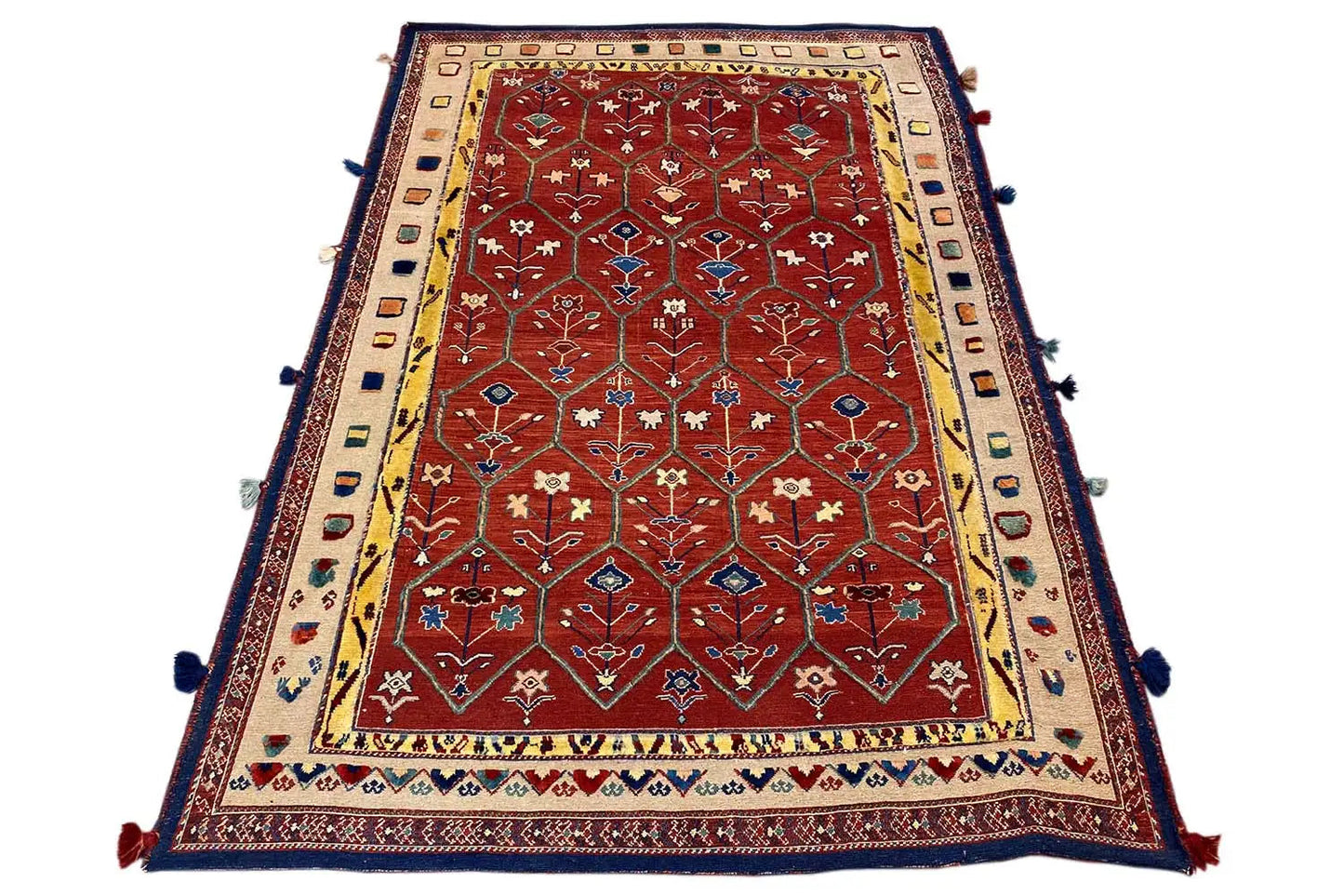Reddish-brown Oriental rug with a wide border, blue edging, and tassels at the corners