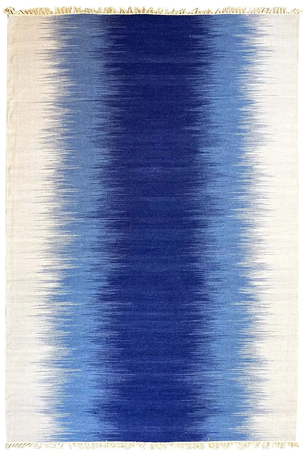 Rectangular kilim dhurrie rug in light beige with a blue central area and fringes