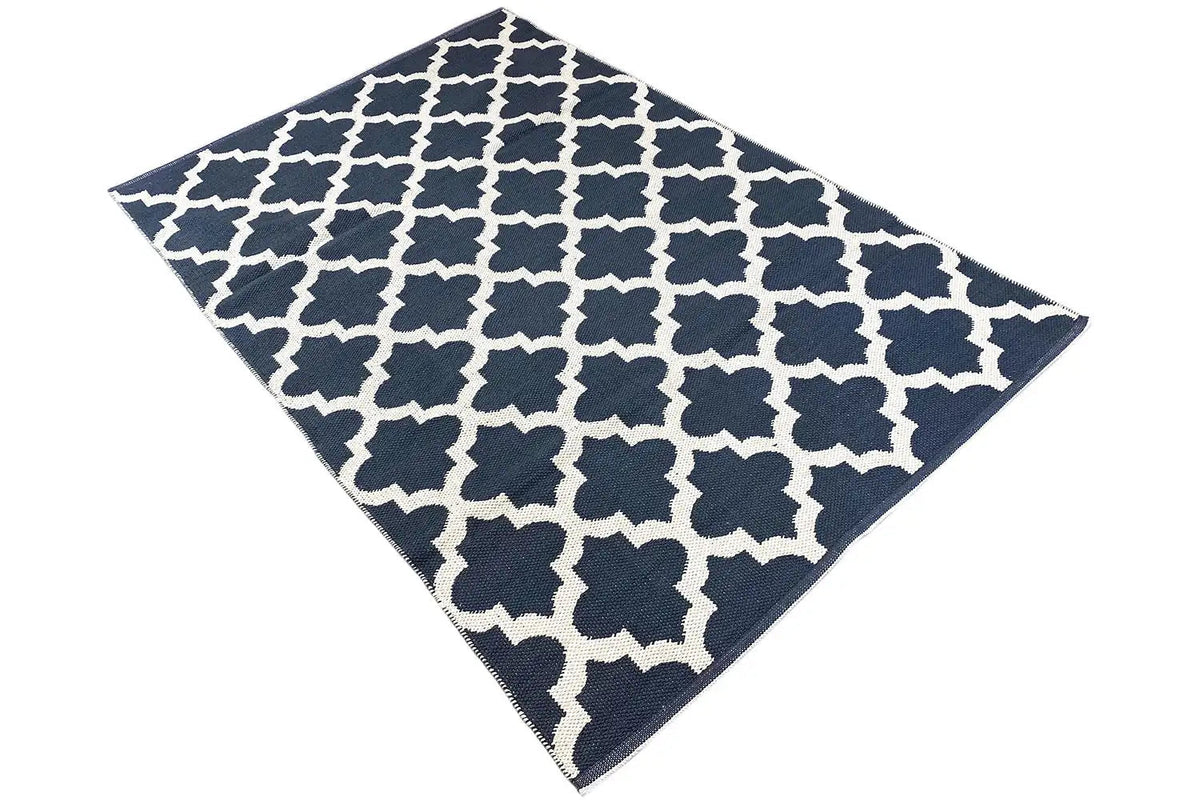 Kilim rug shown square/diagonally: white pattern on a dark blue background