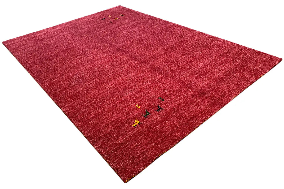 Red Gabbeh rug with multicolored ornaments, diagonal view