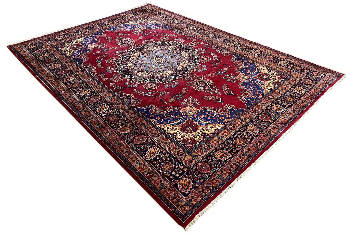 Rug with a red central field, dark blue border, and richly ornamented pile