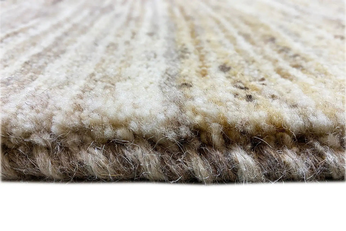 Gabbeh rug detail at the edge: light pile with darker areas, thick border