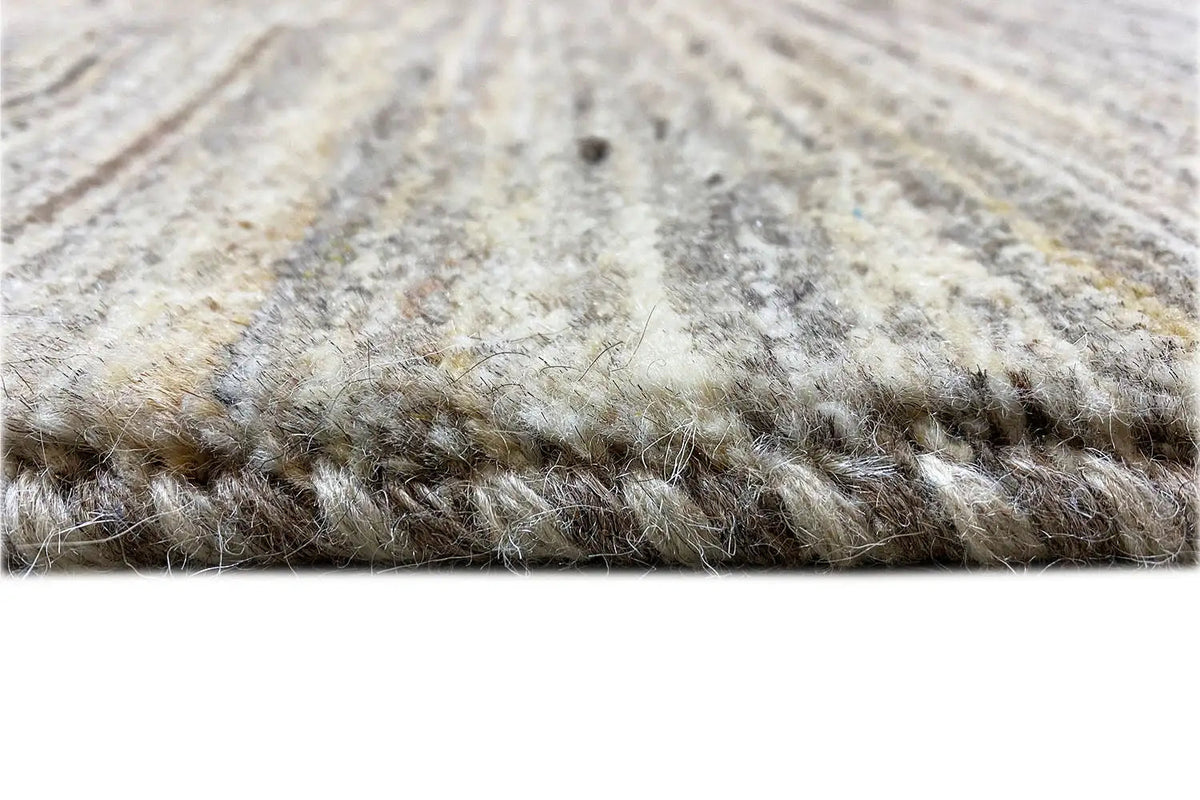 Close-up of a Gabbeh rug with pile and brown-gray edge