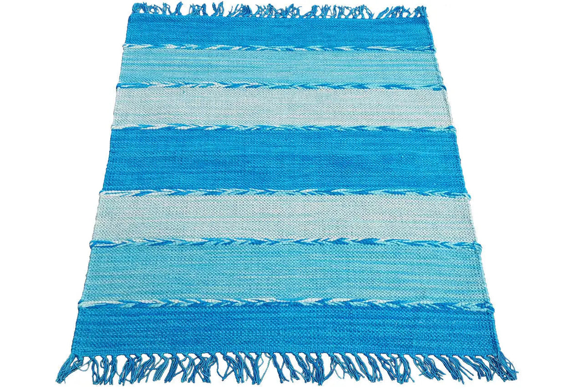 Striped kilim dhurrie rug in turquoise and light blue, with fringes along the edges